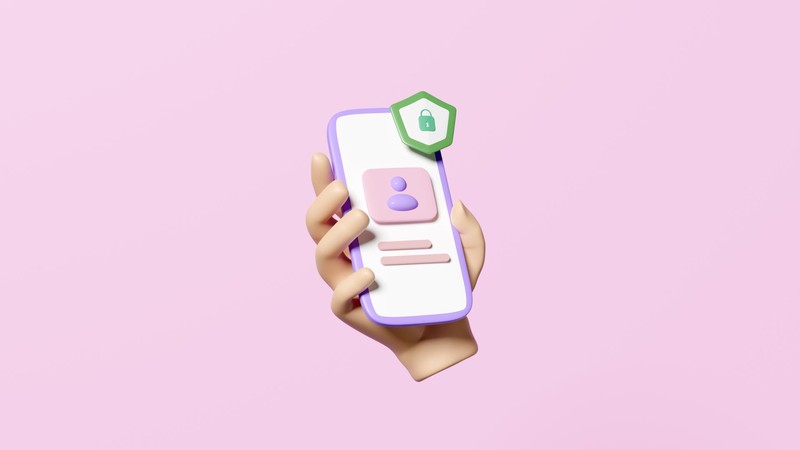Hand mit Smartphone auf pinkem Hintergrund